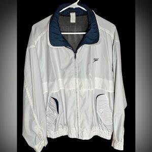 Men's small Speedo windbreaker jacket with
white nylon shell & navy blue lining.